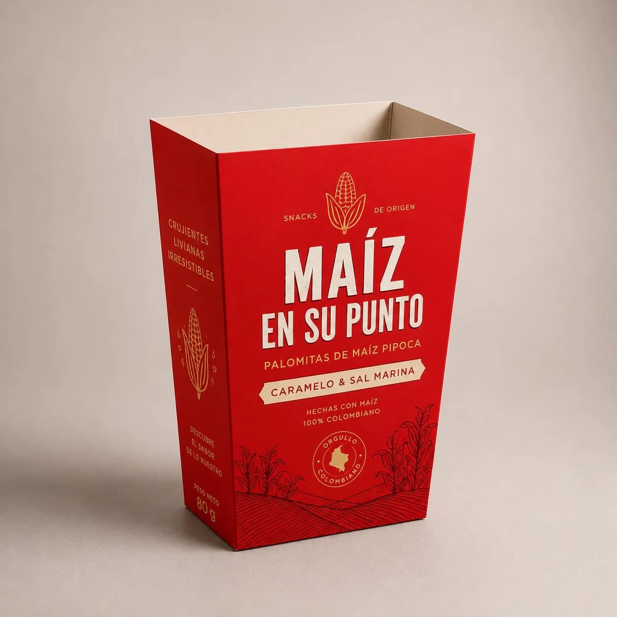 Caja premium de palomitas con diseño rojo inspirado en maíz colombiano y estilo artesanal moderno.